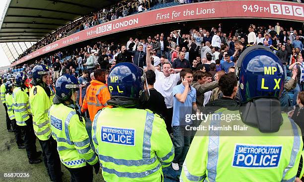 Police keep themselves between the pitch and the Millwall fans after the Coca Cola League One Play-off Semi Final First Leg between Millwall and...