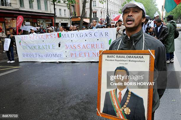 People protest, on May 9 in Paris, to denounce the current situation in Madagascar after army-backed opposition leader Andry Rajoelina forced Marc...