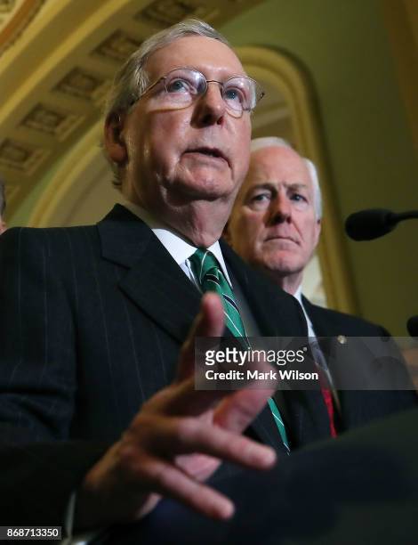 Senate Majority Leader Mitch McConnell , is flanked by Sen. John Cornyn as he speaks about the Senate's agenda after attending the Senate GOP policy...
