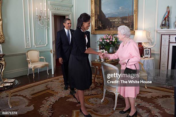 In this handout provide by the White House, U.S. President Barack Obama and First Lady Michelle Obama are welcomed by Her Majesty Queen Elizabeth II...