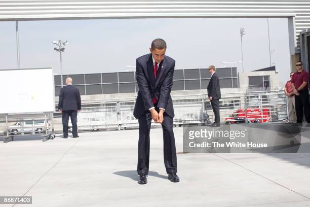In this handout provide by the White House, U.S. President Barack Obama practices his golf swing at an outdoor hold prior to an event at the Miguel...