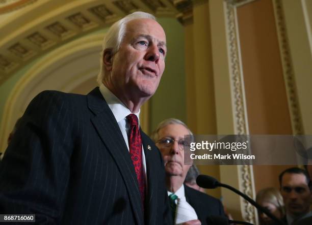 Sen. John Cornyn is flanked by Senate Majority Leader Mitch McConnell as he speaks about the Senate's agenda after attending the Senate GOP policy...