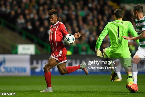 Kingsley Coman of Bayern Muenchen takes the ball around the keeper on his way to scoring the first goal during the UEFA Champions League group B...
