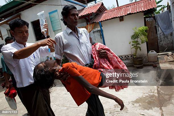 Burmese -Rohingya woman is carried by her husband suffering from HIV at a special clinic for AIDS on April 25, 2009 in Yangon, Myanmar . The...