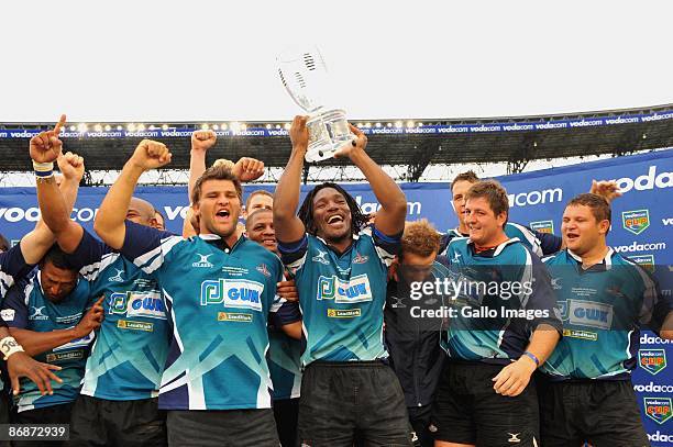 Griques players celebrate with the Trophy after winning the Vodacom Cup final match between Blue Bulls and GWK Griquas at Loftus Versfeld Stadium on...