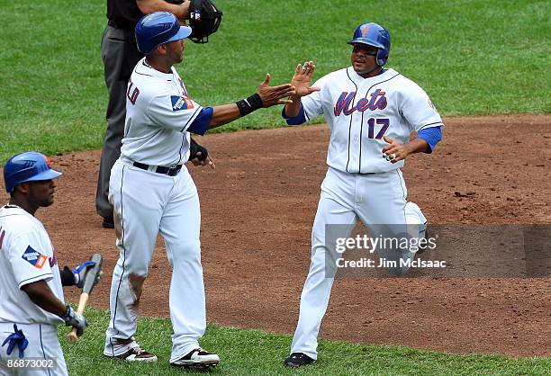 Fernando Tatis and Gary Sheffield of the New York Mets celebrate after scoring in the fourth inning against the Pittsburgh Pirates after a base hit...