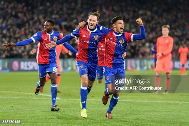 Basel's Swiss midfielder Luca Zuffi celebrates with teammates Italian defender Raoul Petretta after scoring a goal during the UEFA Champions League...