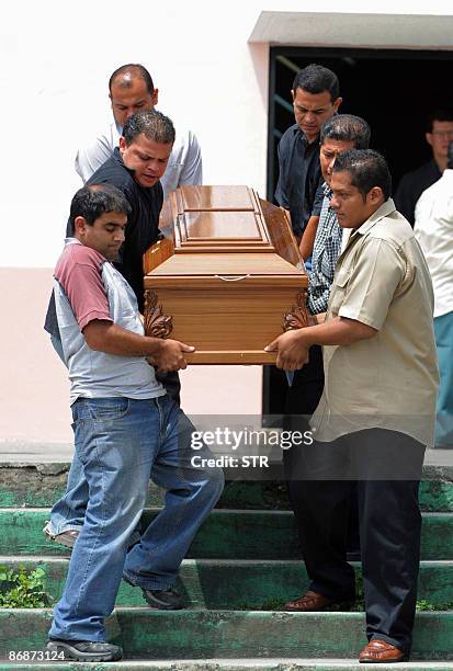 Relatives of Manuel de Jesus Arevalo Ramirez carry his coffin on May 9 at San Antonio de Coronado church. Arevalo Ramirez, who suffered from diabetes...