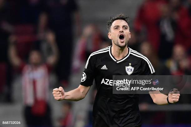 Qarabag's Spanish midfielder Michel celebrates a goal during the UEFA Champions League football match Club Atletico de Madrid vs Qarabag FK at the...