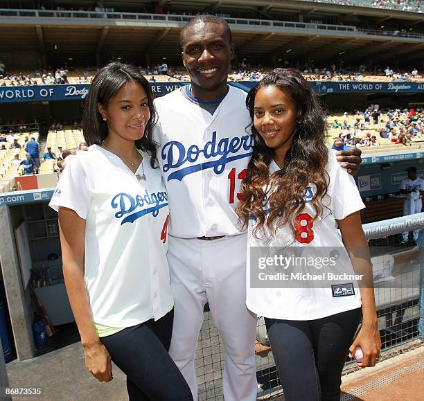 Designer Vanessa Simmons, Los Angeles Dodger's Orlando Hudson and designer Angela Simmons pose before throwing out the first pitch at Dodger Stadium...