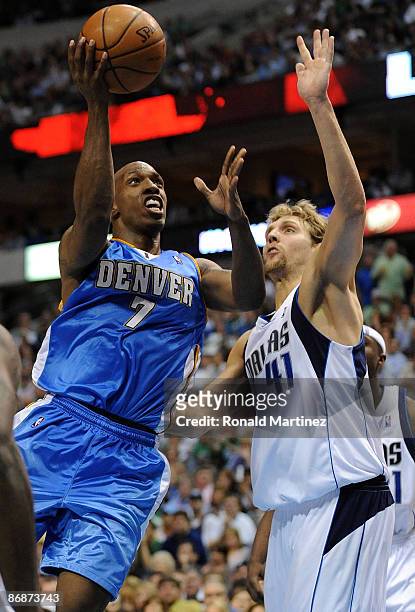 Guard Chauncey Billups of the Denver Nuggets takes a shot against Dirk Nowitzki of the Dallas Mavericks in Game Three of the Western Conference...