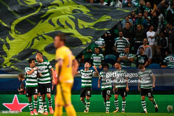 Sporting players celebrate after Sporting's Brazilian midfielder Bruno Cesar scored against Juventus FC during the Champions League, Group D,...