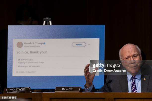 With a display showing President Donald Trump retweeting a fake Russian Twitter account, Sen. Patrick Leahy questions witnesses during a Senate...