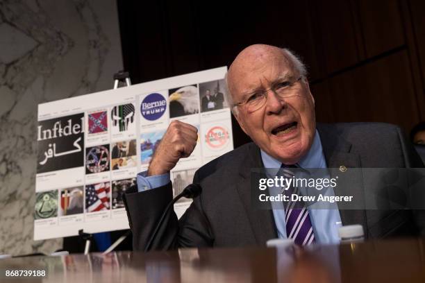 With examples of Russian-created Facebook pages behind him, Sen. Patrick Leahy questions witnesses during a Senate Judiciary Subcommittee on Crime...