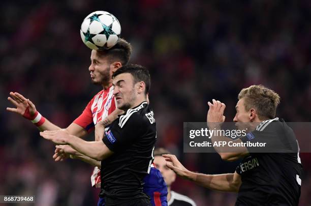 Atletico Madrid's Spanish midfielder Saul Niguez heads the ball with Qarabag's Azerbaijani midfielder Gara Garayev during the UEFA Champions League...