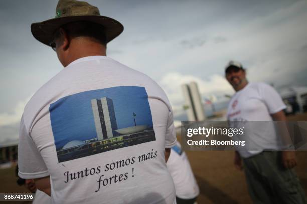 Taxi driver wears a shirt that reads "Together We Are Stronger" during protest in support of a proposed law that would regulate Uber Technologies...