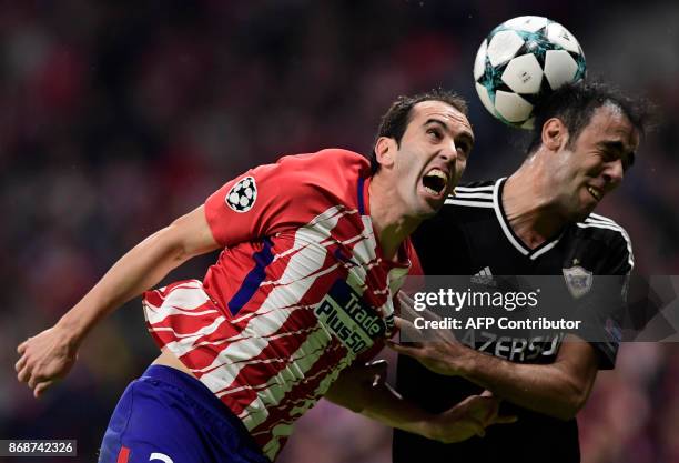 Atletico Madrid's Uruguayan defender Diego Godin vies with Qarabag's Azerbaijani defender Elvin Yunuszada during the UEFA Champions League football...