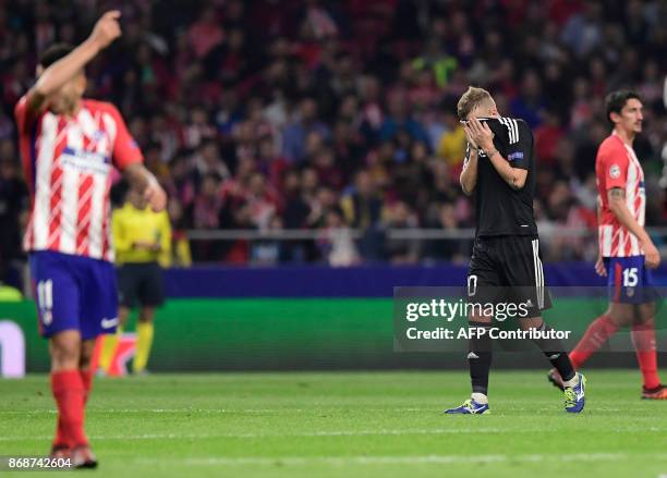 Qarabag's Brazilian midfielder Pedro Henrique covers his face after receiving a red card during the UEFA Champions League football match Club...