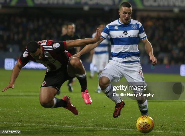 Cameron Carter-Vickers of Sheffield United and Conor Washington of Queens Park Rangers battle for possession during the Sky Bet Championship match...