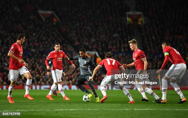 Douglas of Benfica is watched by Manchester United defence during the UEFA Champions League group A match between Manchester United and SL Benfica at...