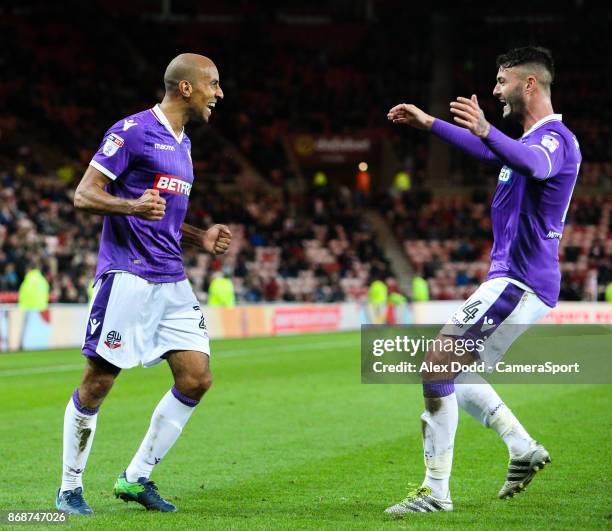 Bolton Wanderers' Karl Henry celebrates scoring his side's third goal with teammate Gary Madine during the Sky Bet Championship match between...