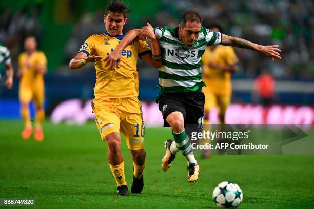 Juventus' Argentinian forward Paulo Dybala vies with Sporting's Brazilian midfielder Bruno Cesar during the Champions League, Group D, football match...