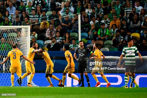 Juventus' Argentinian forward Gonzalo Higuain celebrates a goal with teammates during the UEFA Champions League football match Sporting CP vs...