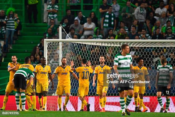 Juventus' Argentinian forward Gonzalo Higuain celebrates a goal with teammates during the UEFA Champions League football match Sporting CP vs...