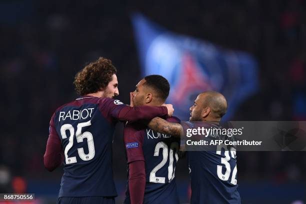 Paris Saint-Germain's French defender Layvin Kurzawa celebrates with teammates afters scoring a goal during the UEFA Champions League Group B...