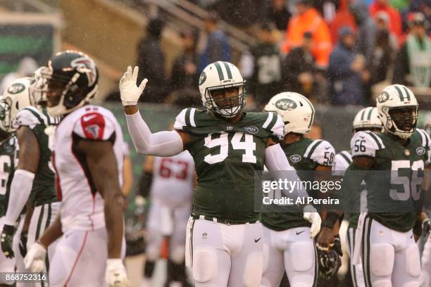 Wide Receivers Coach Karl Dorrell of the New York Jets in action against the Atlanta Falcons in a heavy rain storm during their game at MetLife...