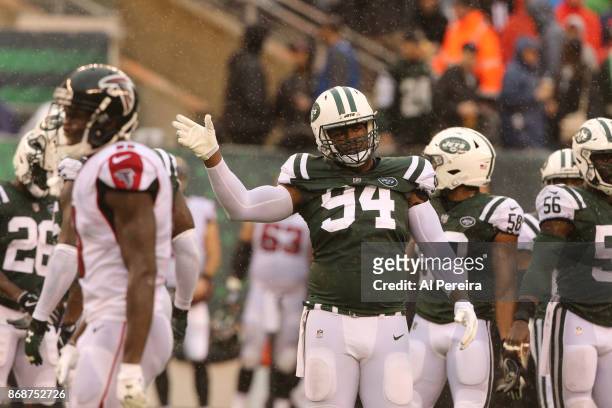 Wide Receivers Coach Karl Dorrell of the New York Jets in action against the Atlanta Falcons in a heavy rain storm during their game at MetLife...