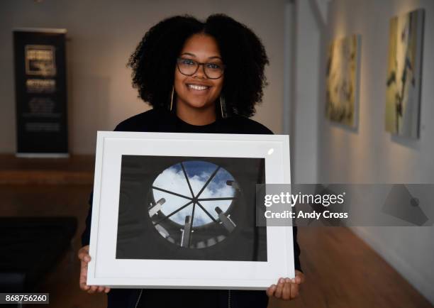 Pablove Foundation program manager and photographer Ashley Blakeney holds an untitled photograph taken by Aspyn, a 14-year-old photographer living...