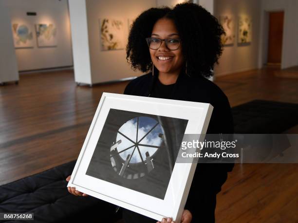 Pablove Foundation program manager and photographer Ashley Blakeney holds an untitled photograph taken by Aspyn, a 14-year-old photographer living...