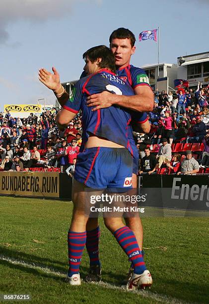 James McManus of the Knights celebrates with team mate Steve Simpson after scoring a try during the round nine NRL match between the Newcastle...