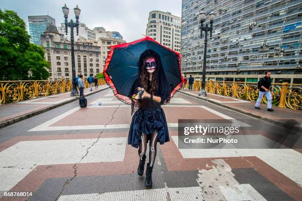 Woman wearing Mexican skull costume and makeup is seen at the Santa Ifigênia Viaduct in São Paulo on 31 October 2017, the day that is celebrated on...