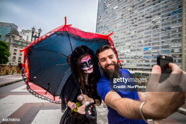 Woman wearing Mexican skull costume and makeup is seen at the Santa Ifigênia Viaduct in São Paulo on 31 October 2017, the day that is celebrated on...