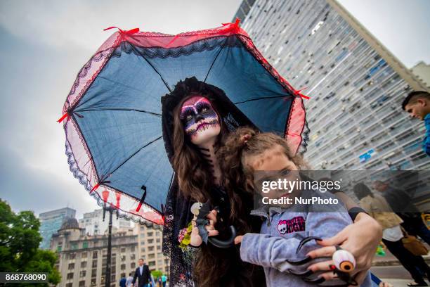 Woman wearing Mexican skull costume and makeup is seen at the Santa Ifigênia Viaduct in São Paulo on 31 October 2017, the day that is celebrated on...