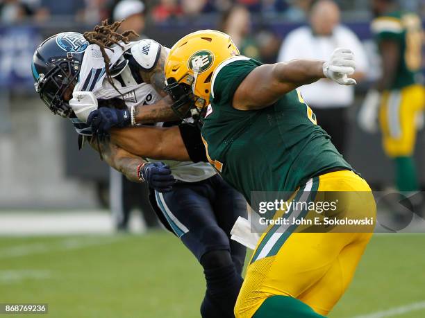 Joel Figueroa of the Edmonton Eskimos blocks Marcus Ball of the Toronto Argonauts during a game at BMO field on September 16, 2017 in Toronto,...