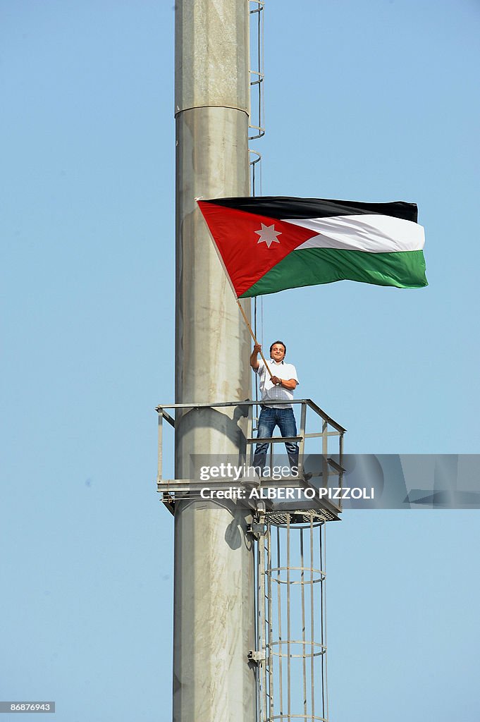 A man waves a Jordanian flag as Pope Ben