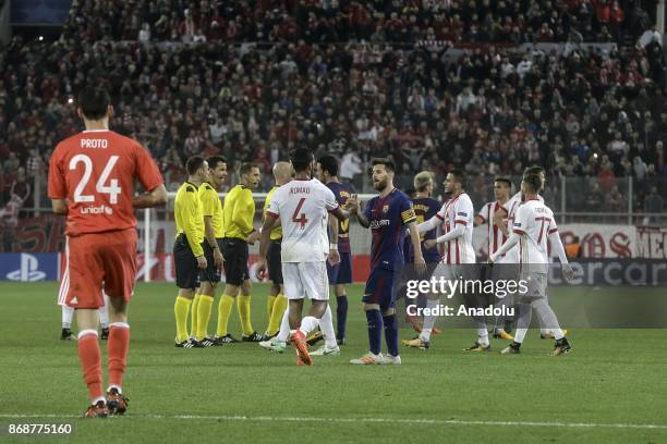 Players congratulate each other after the UEFA Champions League match between Olympiakos and Barcelona at the Giorgos Karaiskakis stadium in Piraeus...