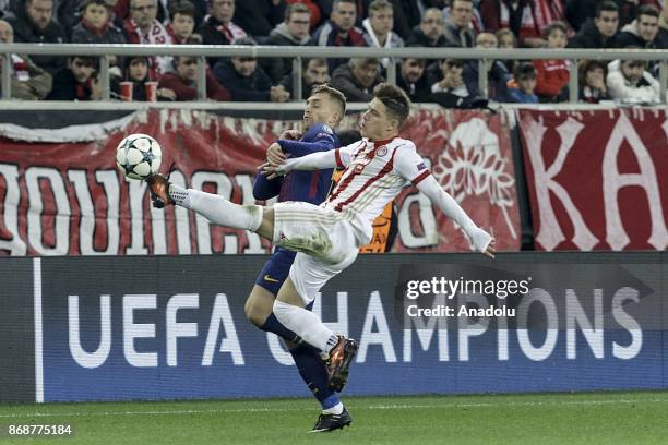 Gerard Deulofeu of Barcelona in action against Leonardo Koutris of Olympiakos during a UEFA Champions League match between Olympiakos and Barcelona...