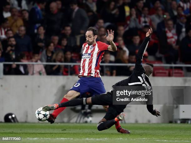 Donald Guerrier of Qarabag FK in action against Juanfran of Atletico Madrid during the UEFA Champions League Group C soccer match between Atletico...