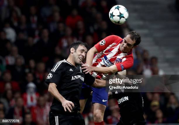 Elvin Yunuszade of Qarabag FK in action against Diego Godin of Atletico Madrid during the UEFA Champions League Group C soccer match between Atletico...