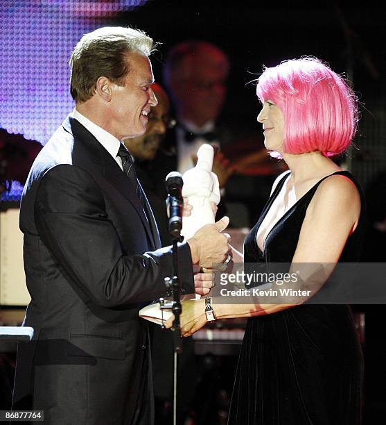 California Governor Arnold Schwarzenegger presents the "Courage To Care" Award to actress Jamie Lee Curtis at the "Noche de Ninos Gala" benefiting...