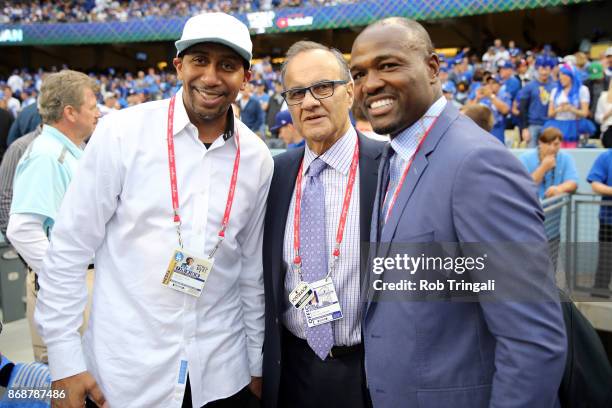 Stephen A. Smith, Major Baseball Chief Baseball Officer Joe Torre, and MLB Network analyst Harold Reynolds pose for a photo on the field prior to...