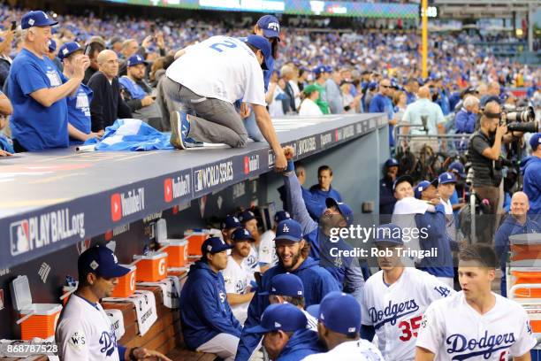 Actor Ashton Kutcher shakes hands with Andre Ethier of the Los Angeles Dodgers prior to Game 6 of the 2017 World Series between the Houston Astros...