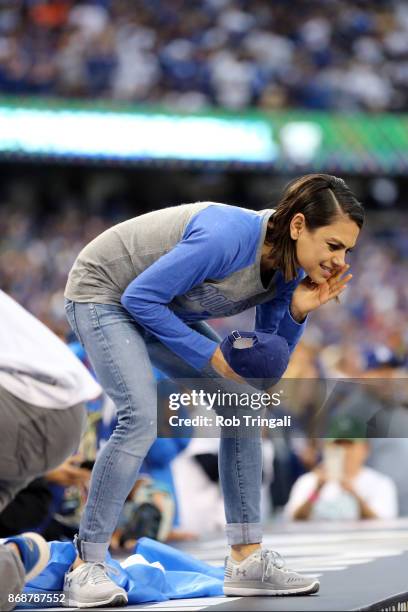 Actress Mila Kunis talks to the Dodger players from atop of the dugout prior to Game 6 of the 2017 World Series between the Houston Astros and the...