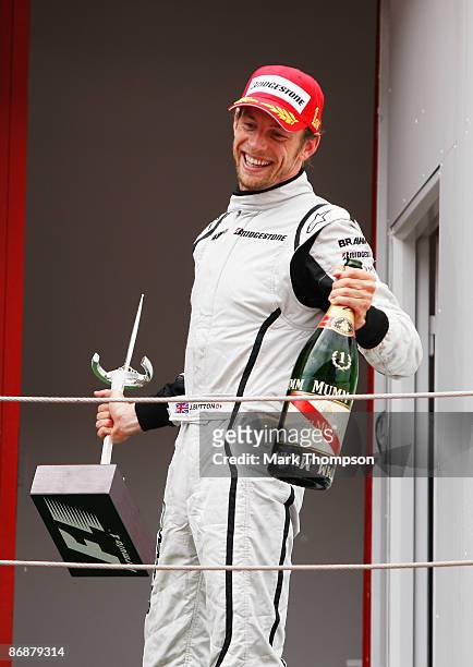 Jenson Button of Great Britain and Brawn GP celebrates on the podium as he wins the Spanish Formula One Grand Prix at the Circuit de Catalunya on May...