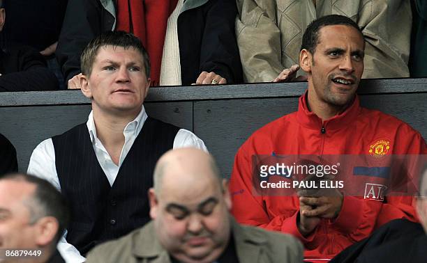 British boxer Ricky Hatton sits with Manchester United's English defender Rio Ferdinand before the English Premier League football match against...