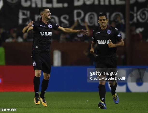 Alejandro Silva of Lanus celebrates with teammate Jose Sand after scoring the fourth goal of his team during a second leg match between Lanus and...